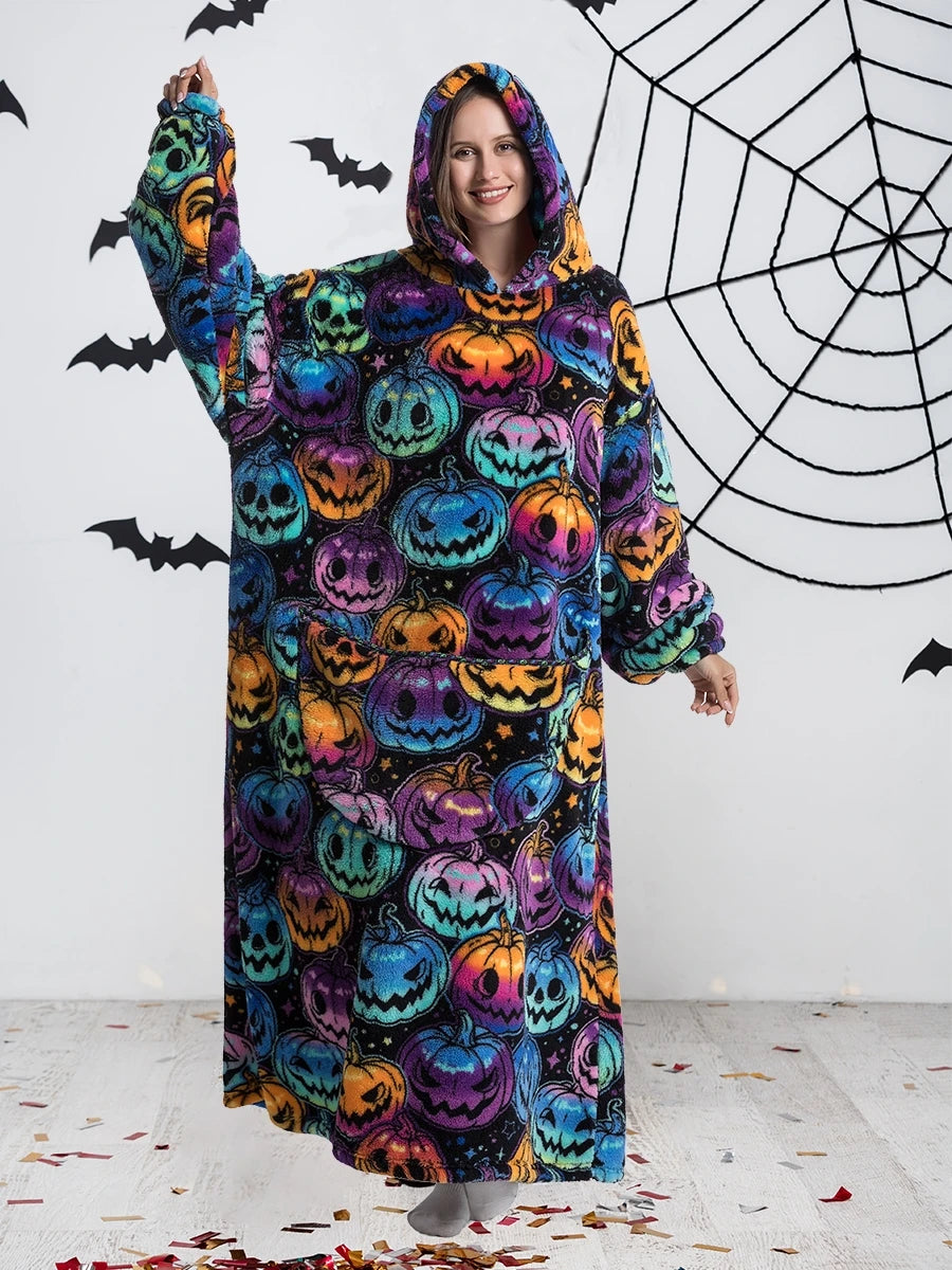 Woman wearing colorful pumpkin print oversized hoodie blanket, front