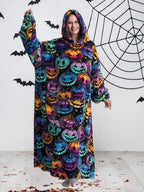 Woman wearing colorful pumpkin print oversized hoodie blanket, front