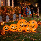 7 ft inflatable pumpkins glowing at night in a decorated Halloween yard with tombstones and string lights, connected jack-o-lanterns