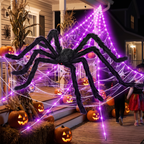 Halloween spider web and giant spider on a decorated porch with pumpkins at night
