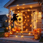 4 foot Halloween spider web with black spider above a front door of a house at dusk
