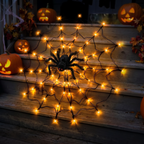 Close up of glowing LED 4 foot spider web with a black furry spider in the center