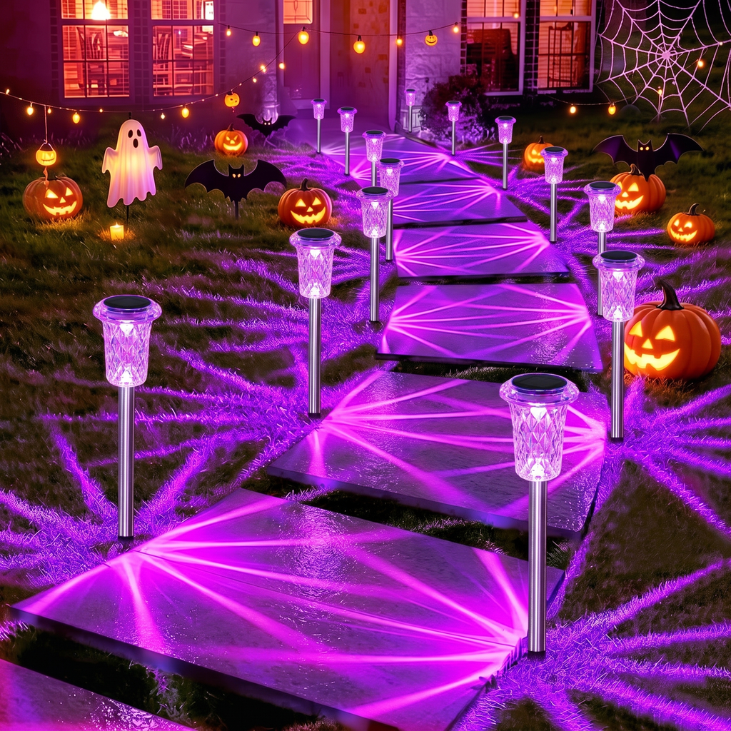 Purple solar pathway lights lining a Halloween decorated walkway with pumpkins at night