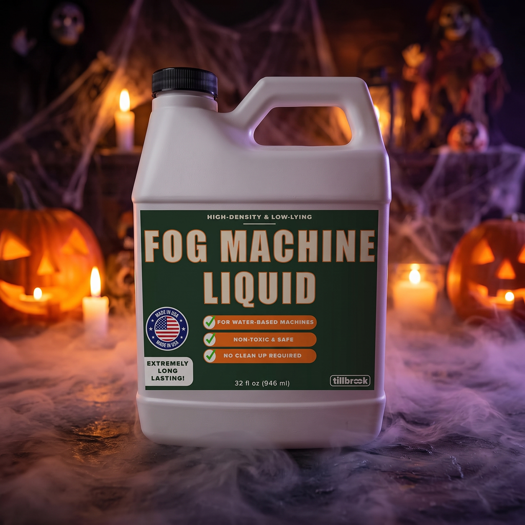 Fog machine liquid bottle with low-lying fog and Halloween decorations at night