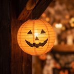 Close up of one glowing paper pumpkin lantern