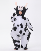 Adult wearing inflatable black and white cow costume, front view