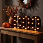 BOO letters on an entryway console at night