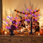 Lit trees on a sideboard at a Halloween gathering
