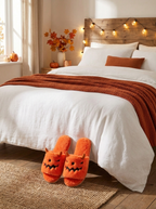 Slippers at the foot of the bed